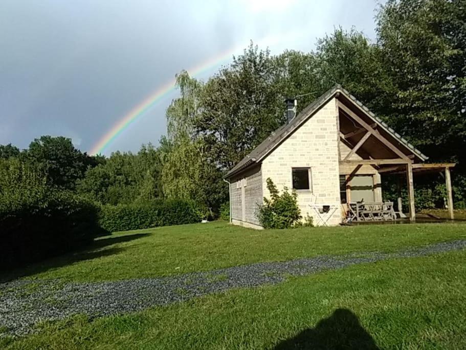 a rainbow in the sky over a barn at Gîte n° 20, en pleine nature, frontalier in Signy-le-Petit