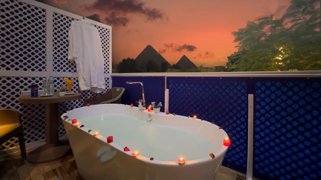 a bathroom with a tub with lights in it at Turquoise Pyramids & Grand Egyptian museum view Hotel in Cairo