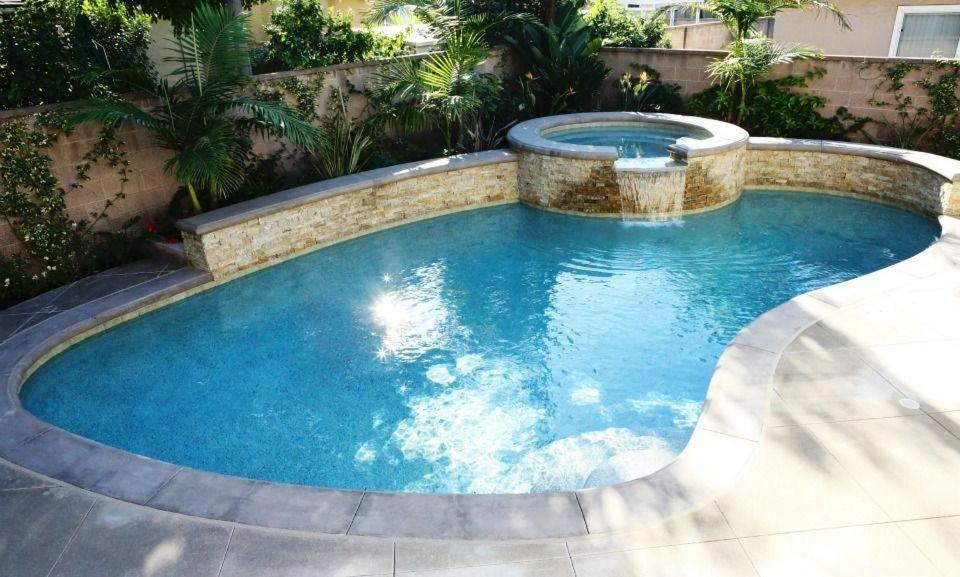 a large pool with a spa in a backyard at Destination #28 in Anaheim