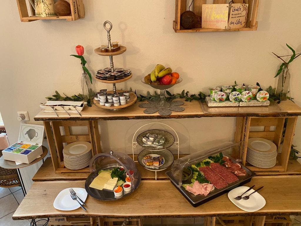 a table with many different types of food on it at Hotel Weinstube am Markt in Gerolzhofen
