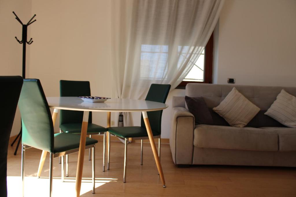 a living room with a table and chairs and a couch at Atlantide holiday apartments in Castellammare di Stabia