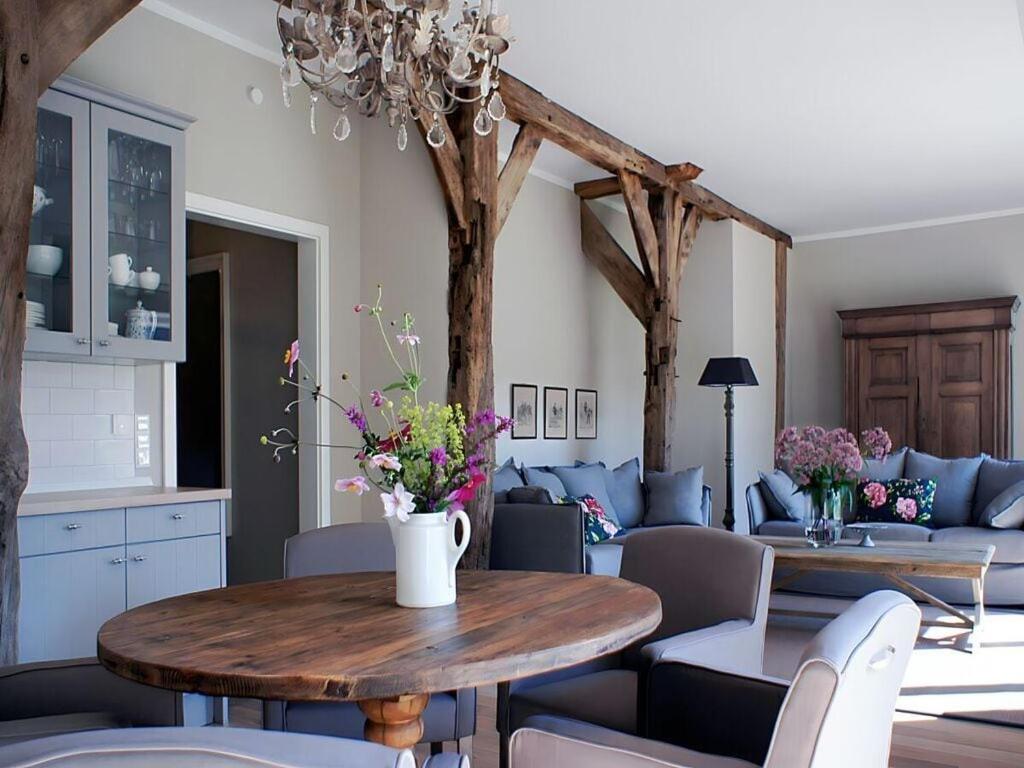 a living room with a table with flowers on it at Appealing apartment in Westerstede in Westerstede