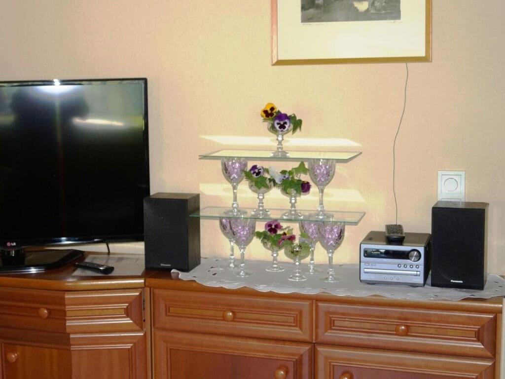 a stand with wine glasses and flowers on top of a dresser at Lovely apartment in Kirn in Kirn