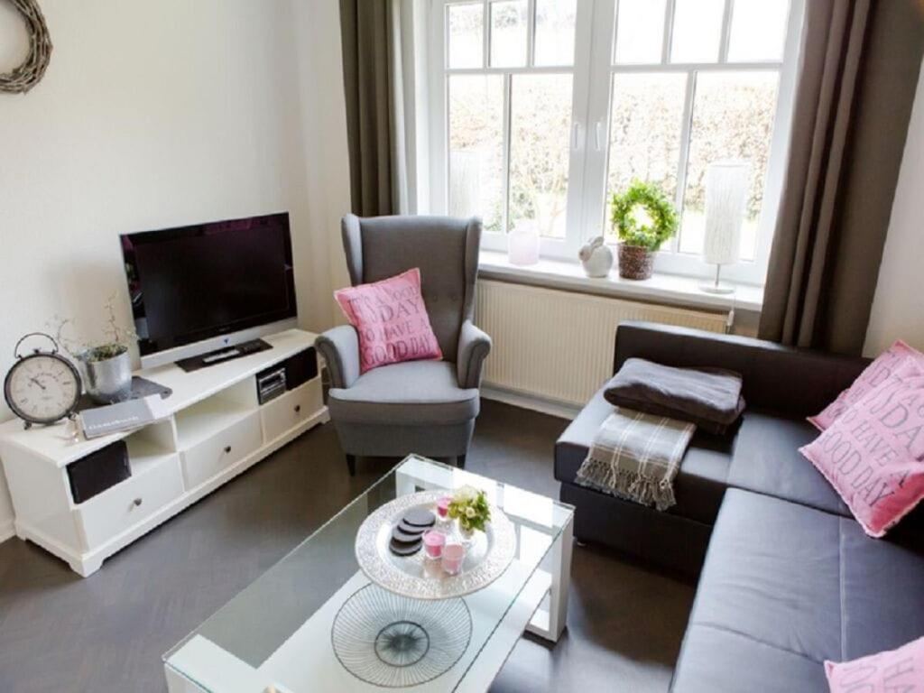 a living room with a couch and a tv at Holiday apartment Ross in Eslohe