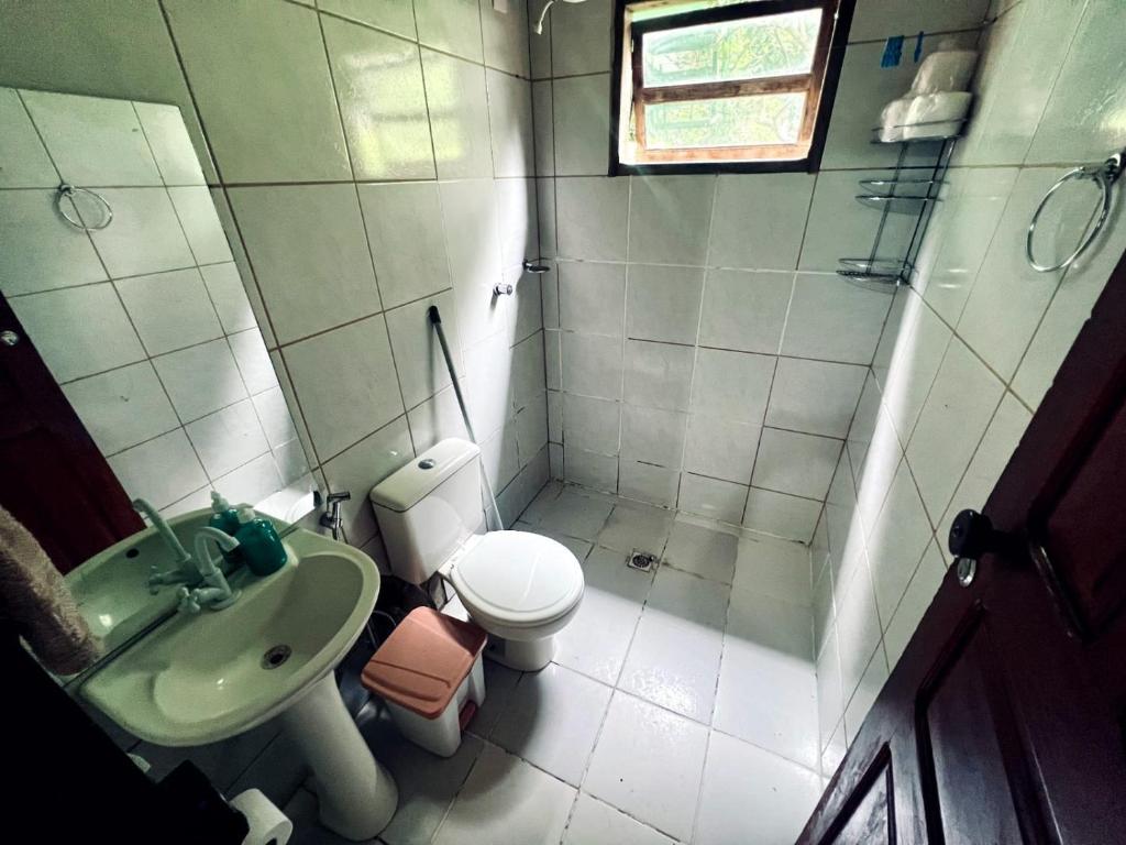 a small bathroom with a sink and a toilet at Casa Tamboril in Sao Jorge