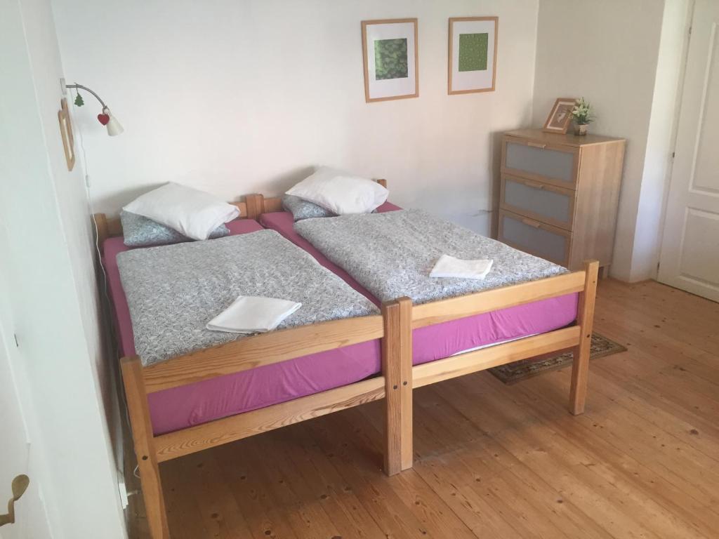 a bedroom with a bed with purple and gray sheets at Apartments at the Golden Plough in Prague