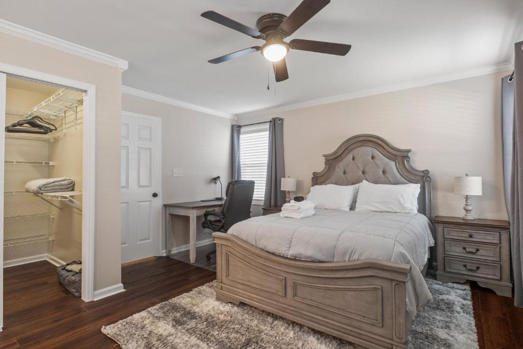 a bedroom with a bed and a ceiling fan at Time To Relax in Raleigh in Raleigh