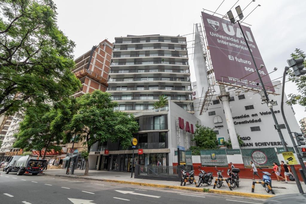 a large building on a city street with people riding motorcycles at Loft Elegante a 5 Minutos de Puerto Madero 6B in Buenos Aires