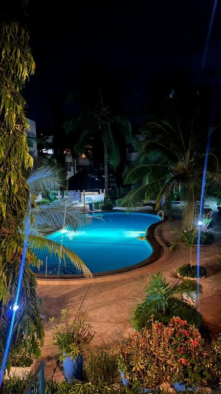 a swimming pool at night with blue lights at Résidence NATANGUE 1 - Studio La Bella in Sali Nianiaral