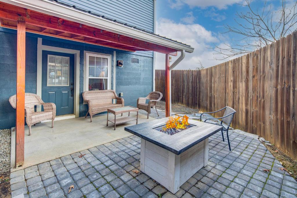 a backyard with a fire pit and a fence at Airy Apartment with Deck - Walk to Main Street! in Hendersonville