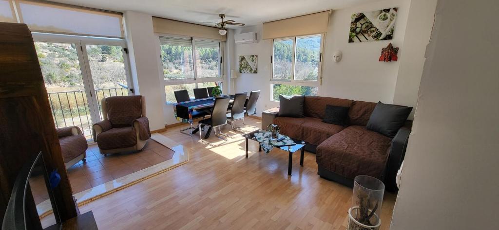 a living room with a couch and a table at APARTAMENTO VISTASALRIO ADRIANA,Montanejos in Montanejos