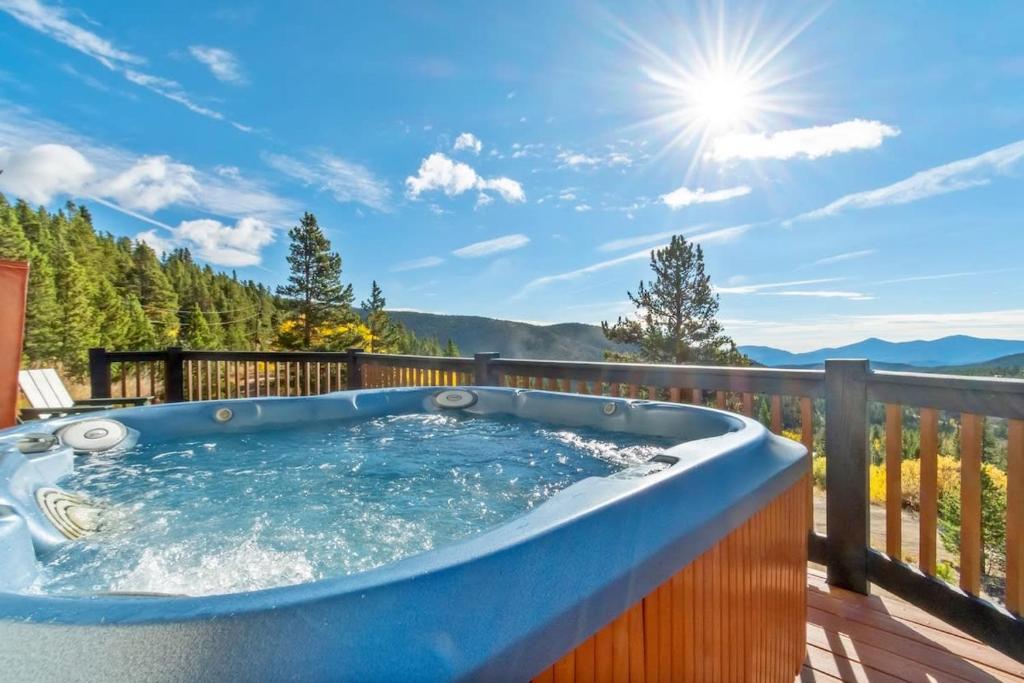 a jacuzzi tub on a deck with a view at St Mary's Glacier Retreat w Hot Tub & Views in Idaho Springs