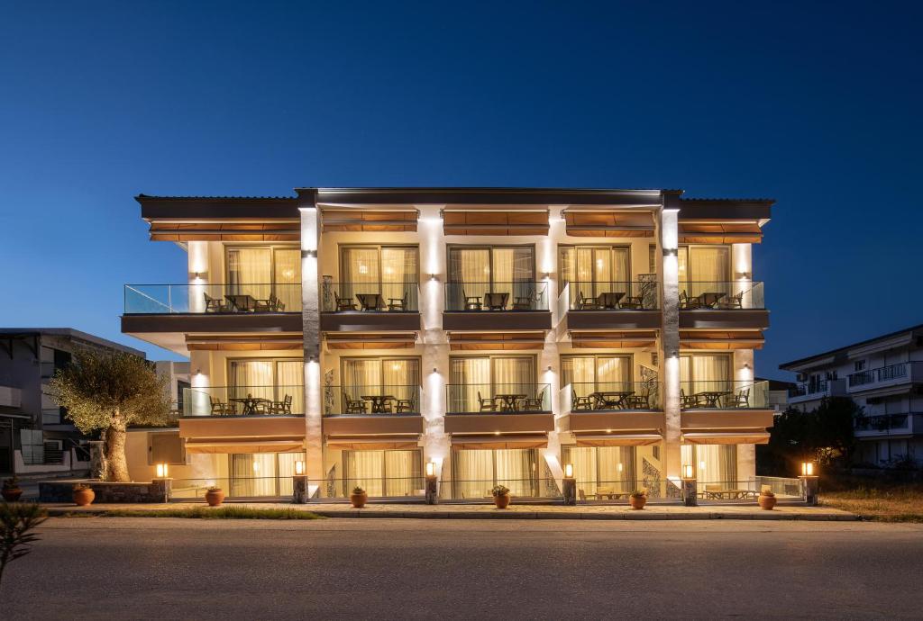 a large building with a fountain in front of it at Ikies Apollon Boutique Hotel in Sarti