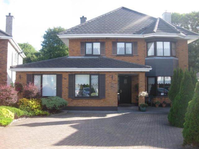 a brick house with a black roof and a driveway at Corrib View Guesthouse h91rr72 in Galway