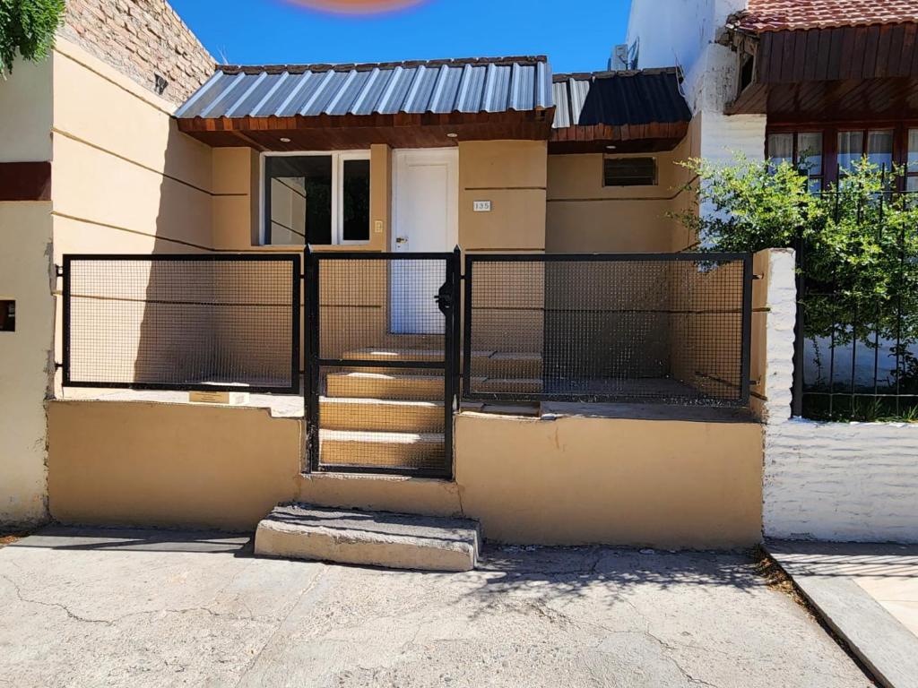 a house with a gate in front of it at DEPARTAMENTO CENTRO in Zapala