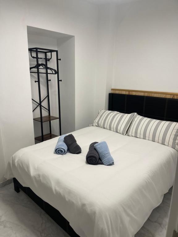 a bedroom with a bed with two towels on it at Castillo Principal in Almansa