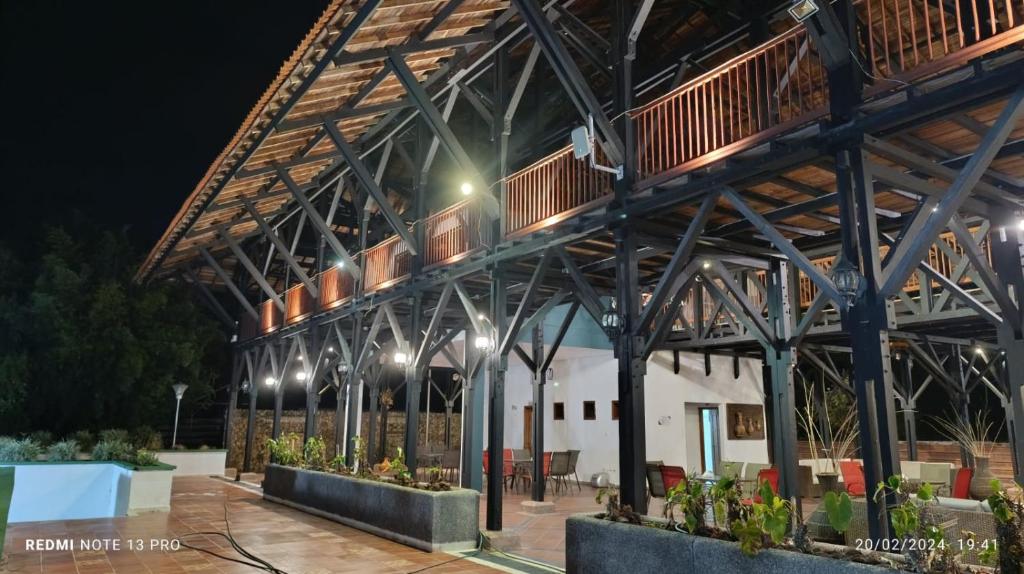 a large metal building with lights on it at night at Finca Santaleja in La Tebaida