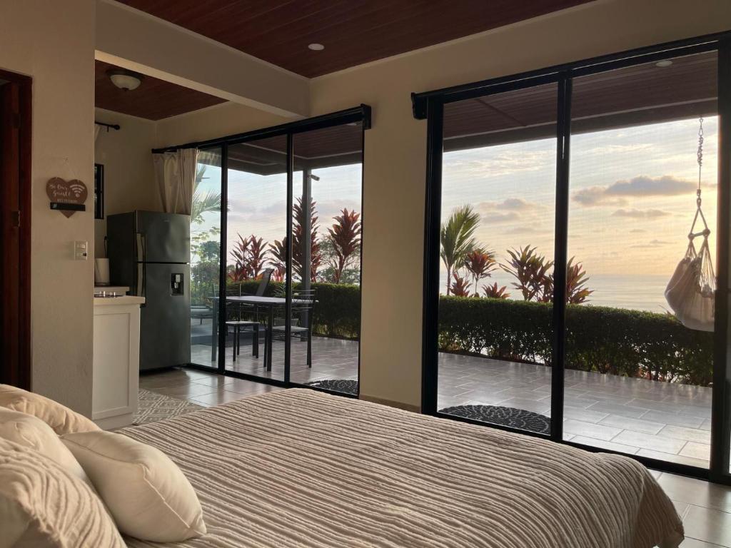 a bedroom with a bed and a view of the ocean at Villa Del Mar 1 Spectacular ocean view! in Dominical