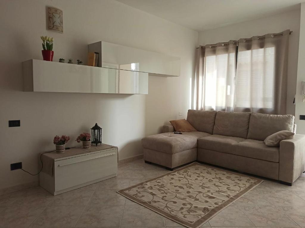 a living room with a couch and a table at Casa Adele in San Sperate