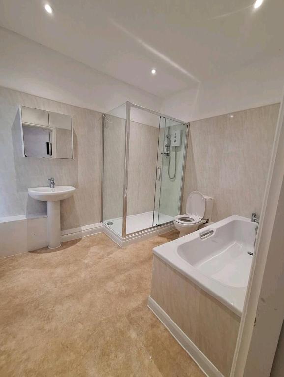 a bathroom with a tub and a toilet and a sink at Favourite Ensuite Room in Middlesbrough