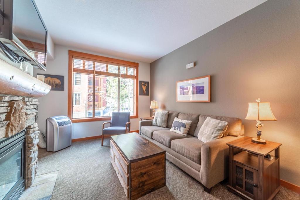 a living room with a couch and a fireplace at 589- Village 1Bed 1Bath Condo with Pool Spa and Walk to Gondola in Mammoth Lakes