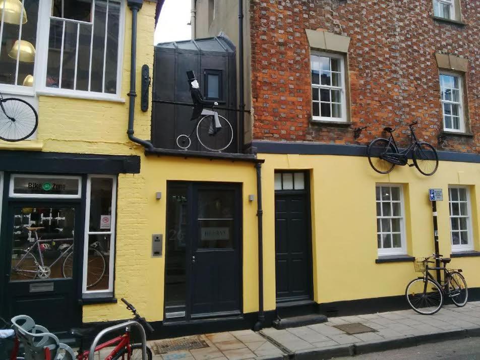 a yellow building with bikes on the side of it at Henry's in Oxford