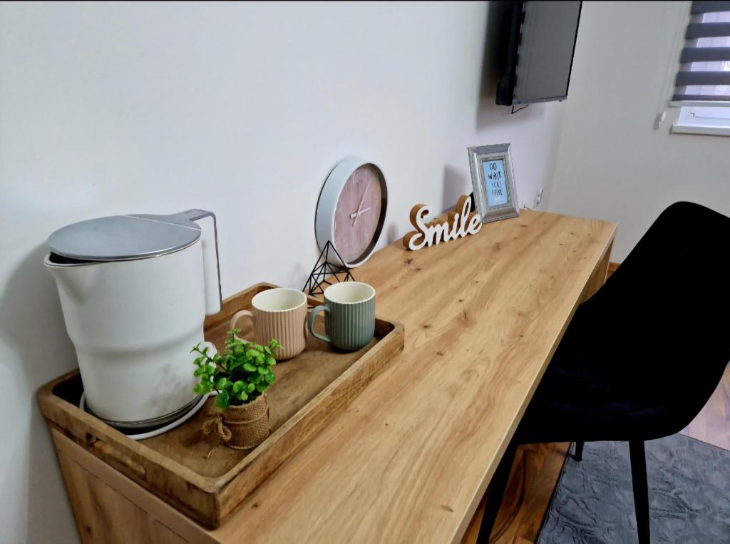 a wooden table with a blender and cups on it at Infinity Apartment & Free Wifi & Free Parking in Sarajevo