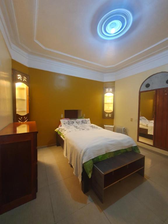 a bedroom with a bed and a dresser and a mirror at Hospedaje Frankenstein in Cusco