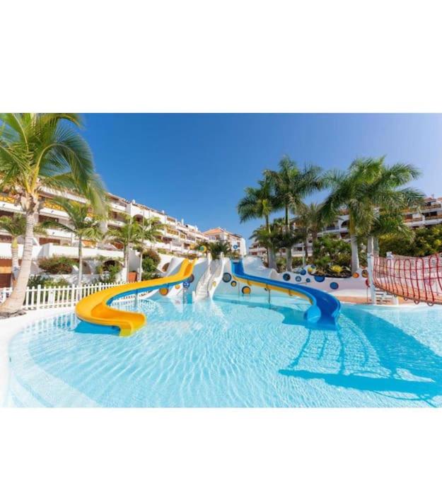 a water slide in a pool at a resort at il centro delle vacanze in Playa de las Americas