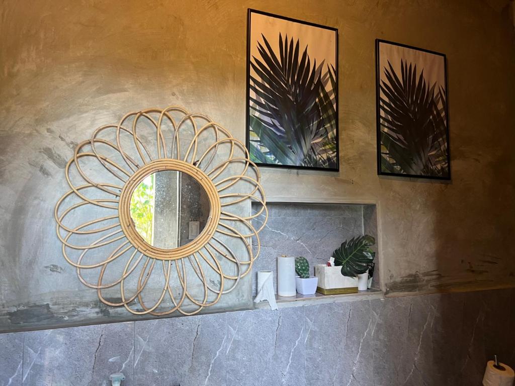 a mirror on a wall in a bathroom at Bintana sa Paraiso Binunsaran in Mambajao