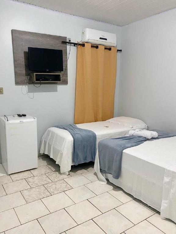Uma cama ou camas num quarto em Pousada Capim Dourado Jalapão São Felix TO