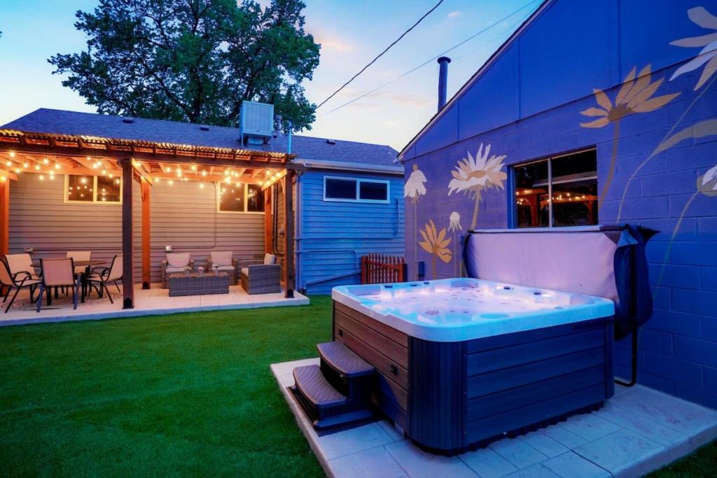 a hot tub in a yard next to a house at One of a Kind Home with HOT TUB Pool Table and Fire Pit 4 Miles to DT in Denver