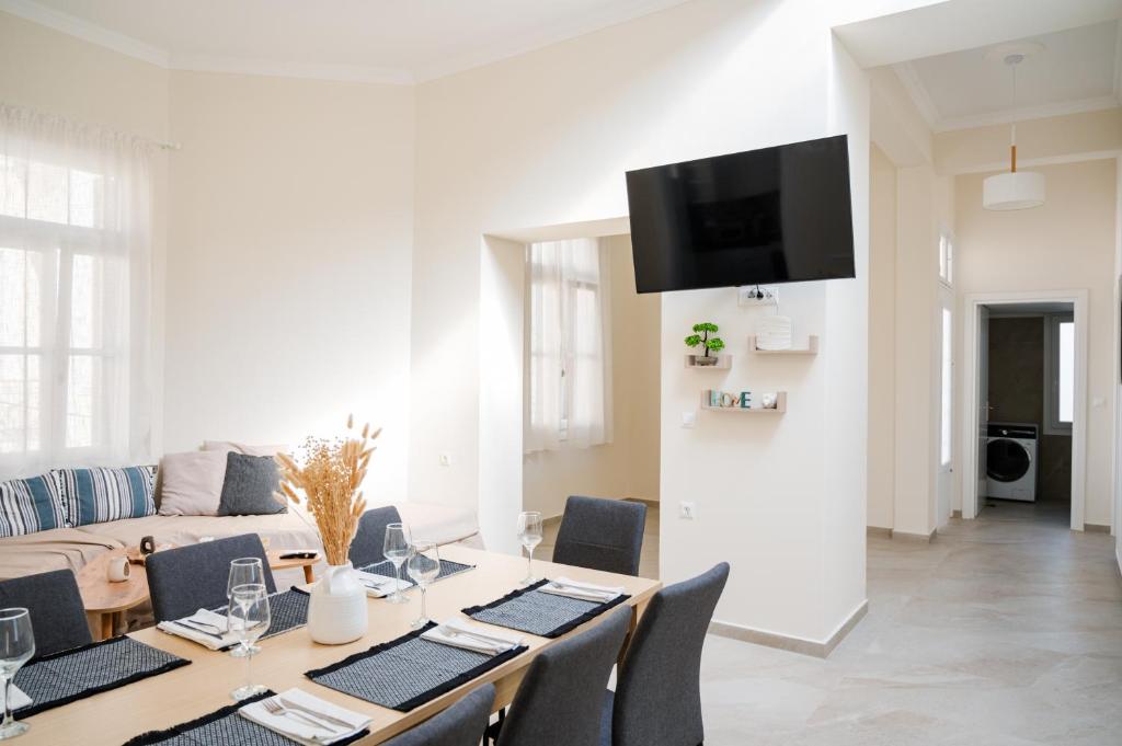 a living room with a table and a couch at Alcestis City Apartment in Rhodes Town
