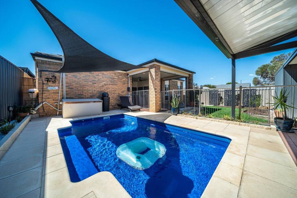 a swimming pool in the middle of a yard at Sailors' Retreat - Family Pool Oasis by Largs Beach in Largs
