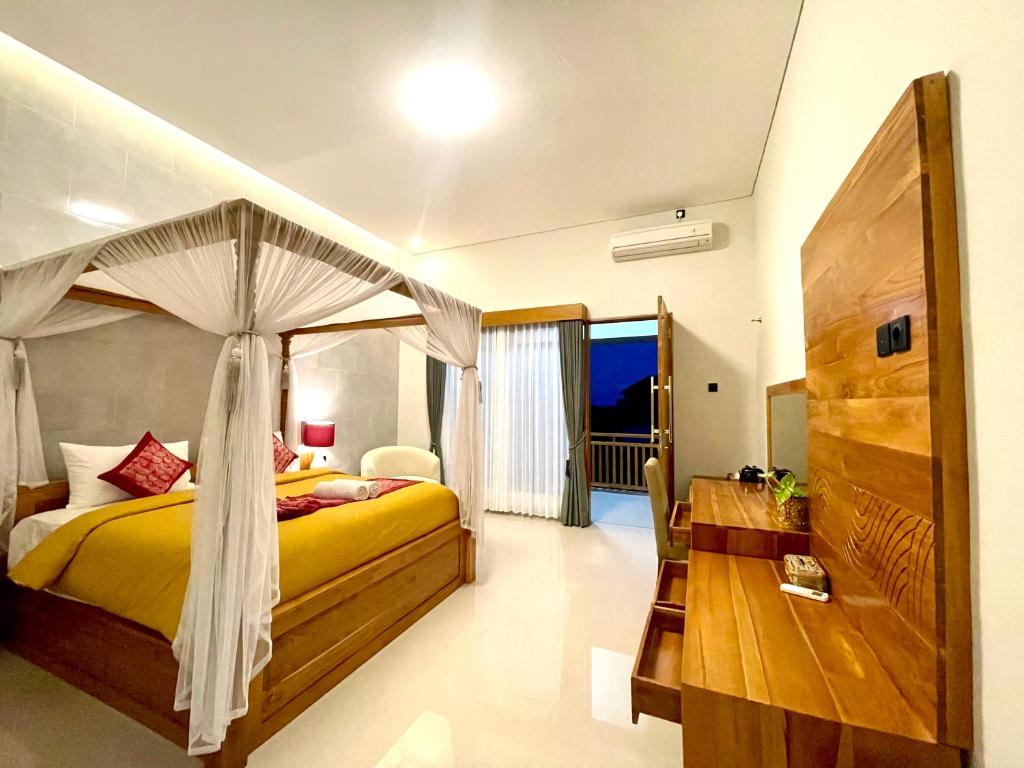 a bedroom with a bed with a canopy at Lebak Bali Batu Mejan in Canggu