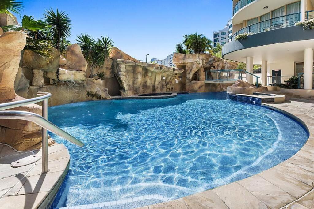a large swimming pool in a building with a resort at Landmark Resort Private Apartment in Mooloolaba