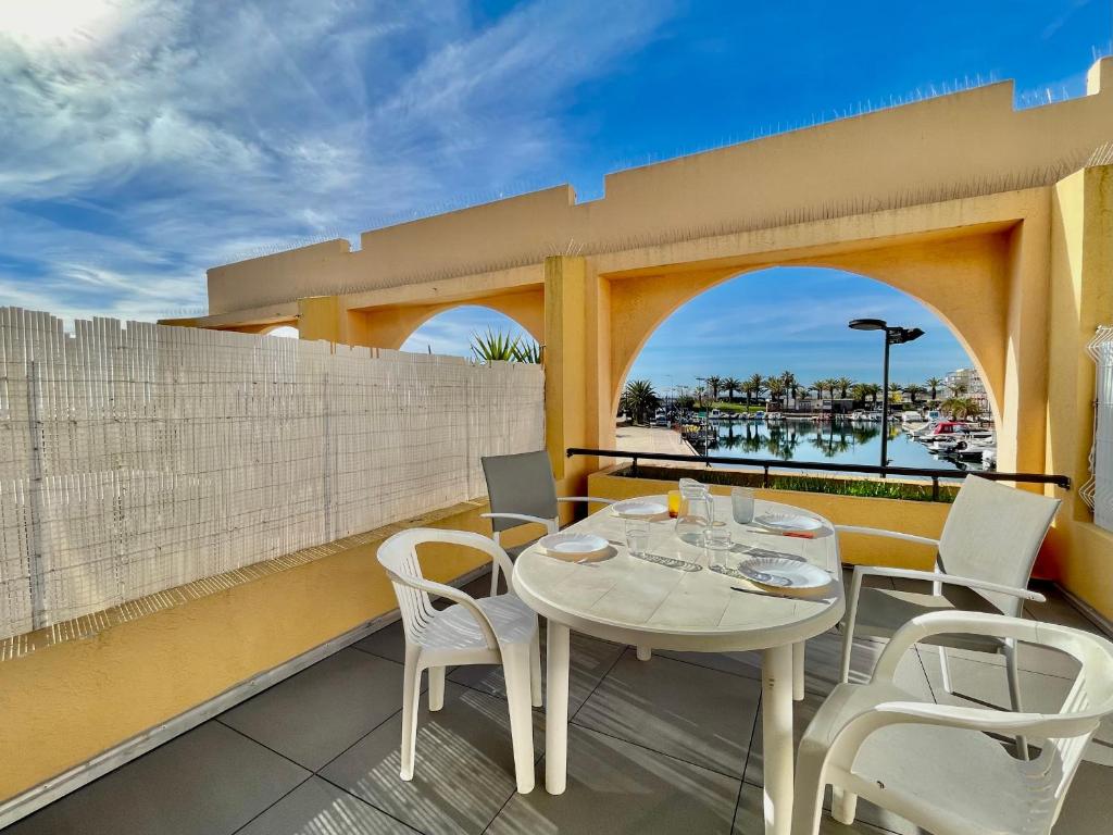 un patio avec une table et des chaises sur un balcon dans l'établissement Studio cabine avec terrasse spacieuse et parking à Sète - FR-1-338-147, à Sète