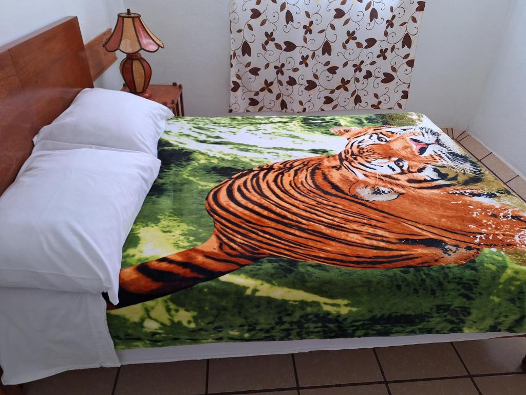 Postel nebo postele na pokoji v ubytování Hostal Casa Del Sol Comitan