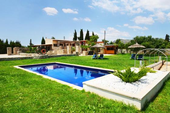 a swimming pool in the middle of a yard at Holiday Home Finca Son Ramon in Llubí