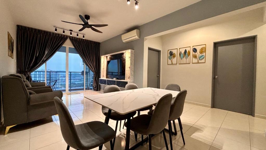 a living room with a dining room table and chairs at NEW Spacious HAUS 4R 8pax WiF-S Pic-Airport in Bayan Lepas