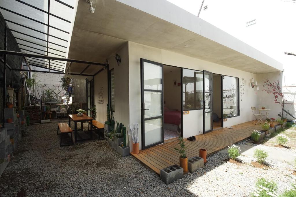 a house with a wooden deck with cactuses at Ngày Tháng 5 - MayDay in Da Lat