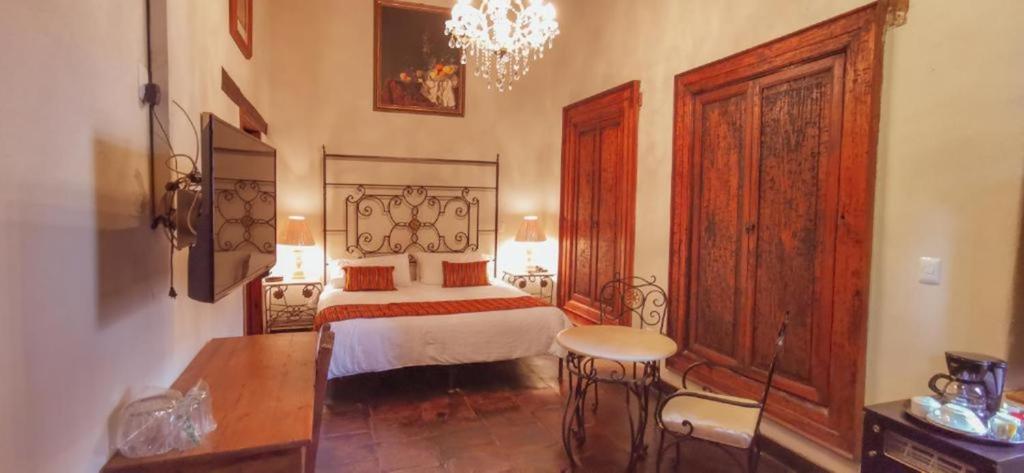 Postel nebo postele na pokoji v ubytování Mansion de los Sueños