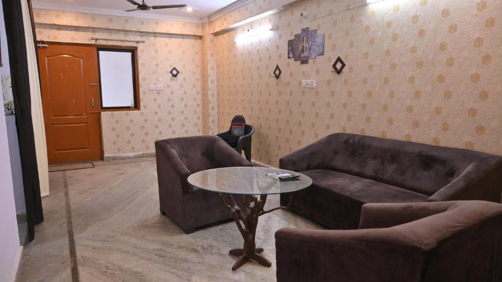 a living room with a couch and a table at Kshitijshomestay in Lucknow