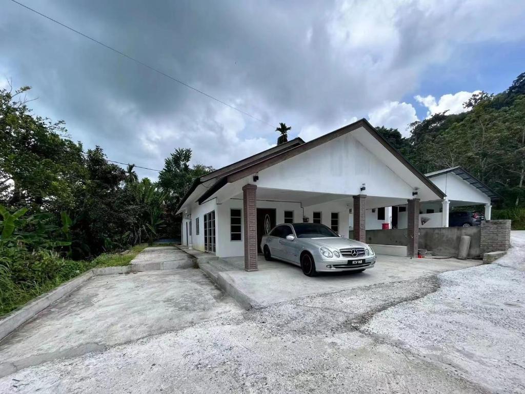 a car parked in front of a building at Vienna home 2 bedrooms+1 workroom for family in Pantai Cenang