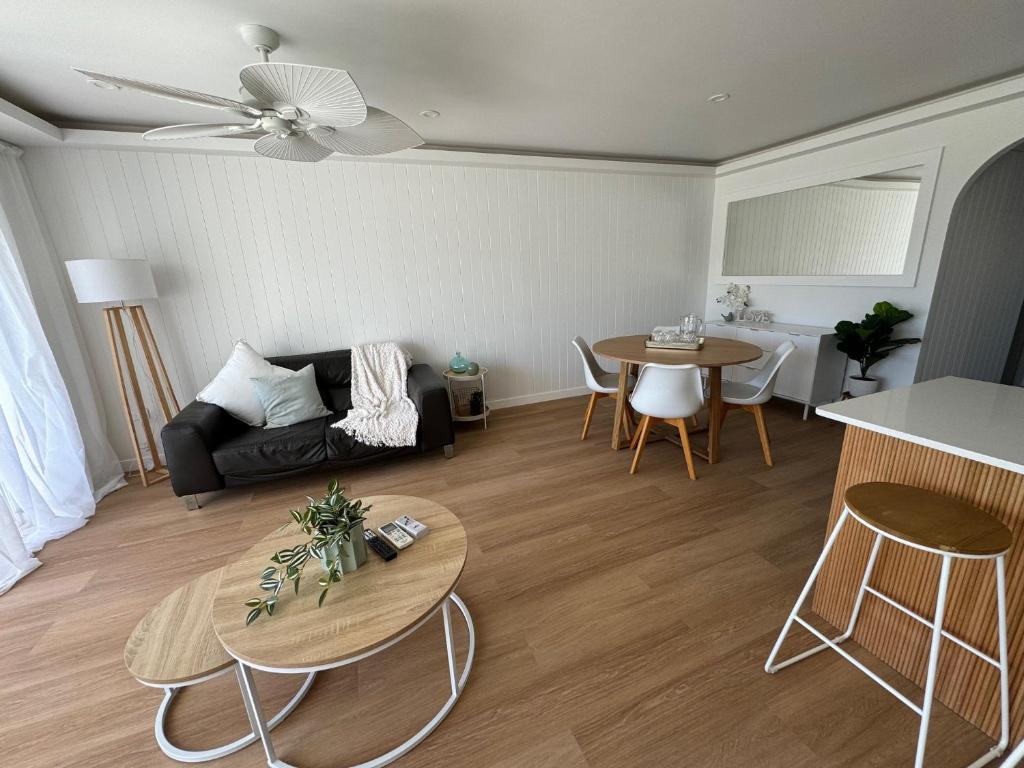 a living room with a couch and a table at Pelican Cove Apartments in Gold Coast