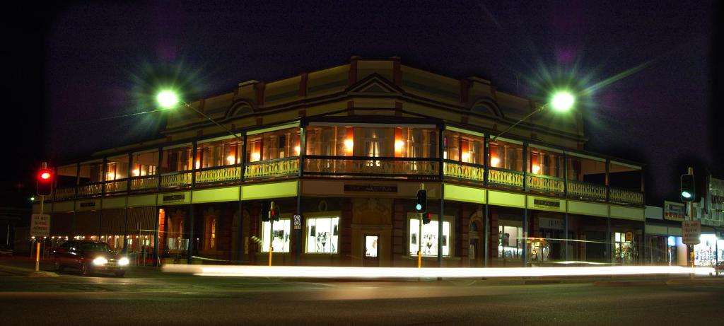 a building at night with two street lights at The Astra Broken Hill in Broken Hill