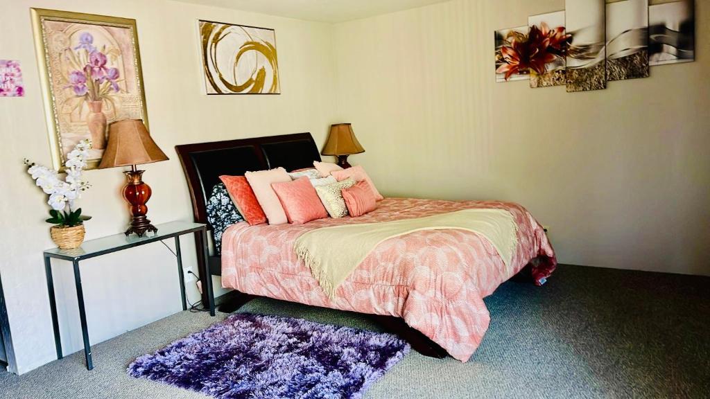 a bedroom with a bed with pink pillows on it at Private Master Bedroom in Santa Clara