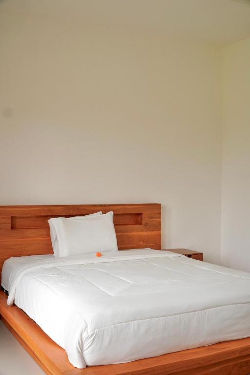 Postel nebo postele na pokoji v ubytování Kayom Rooms
