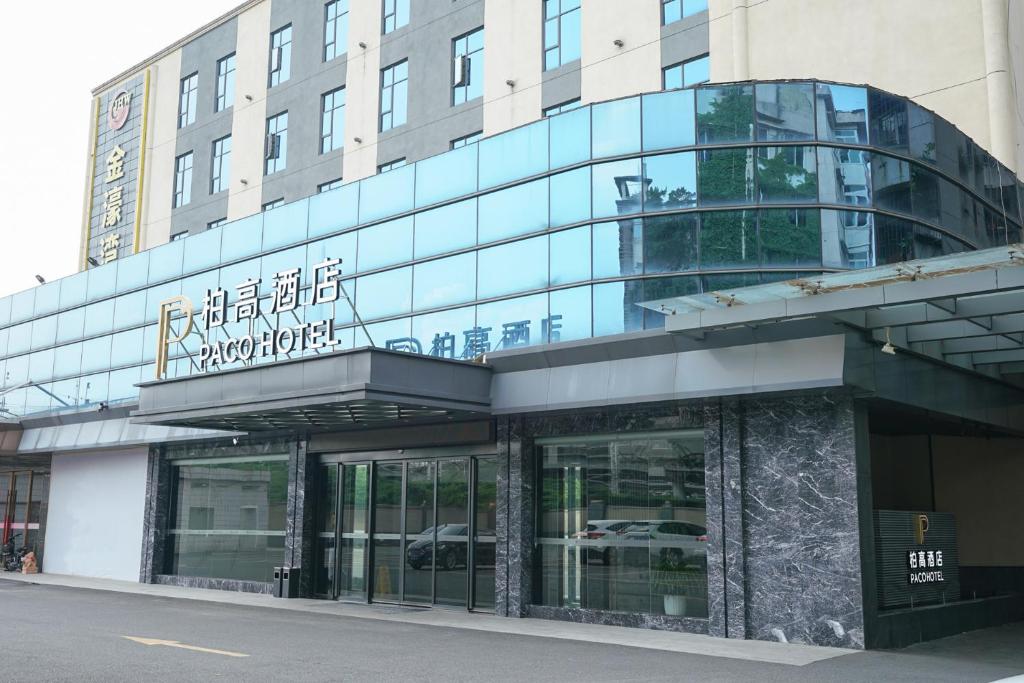 a building with a sign on the front of it at Paco Hotel Guangzhou North Railway Station in Huadu