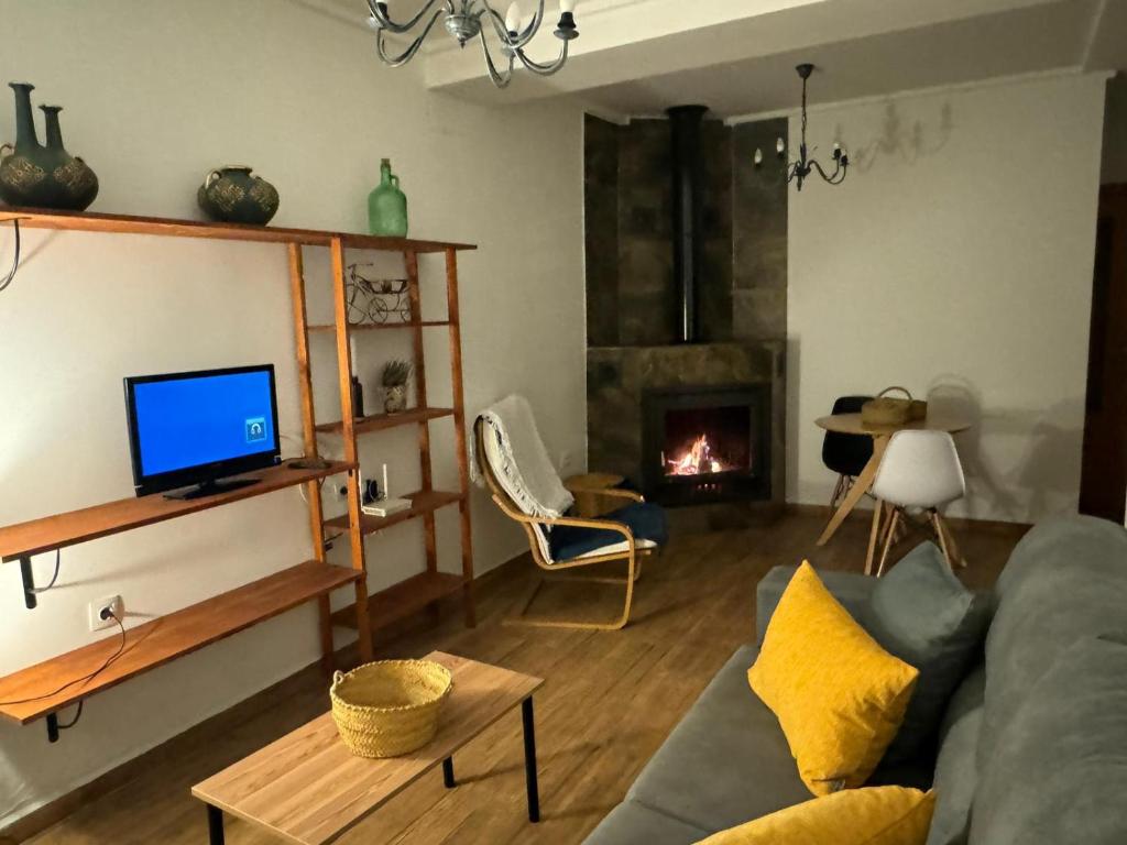 a living room with a couch and a fireplace at Apartamento Irene 1 in Caravaca de la Cruz